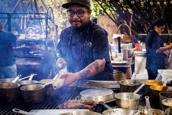 Cook at Deckman's cooking over an open fire