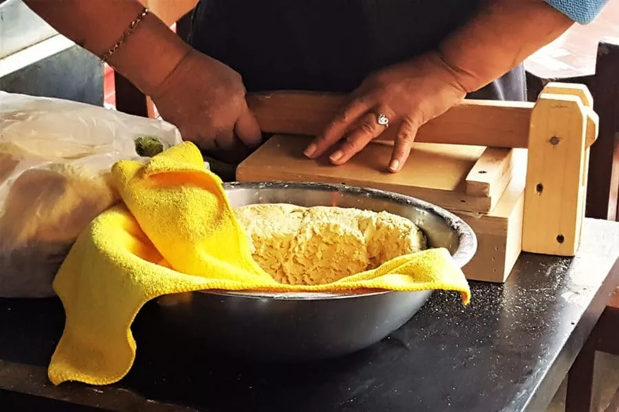 Woman making tortillas at La Tradicion in Plaza Santa Cecilia