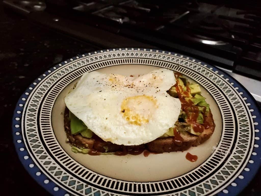 breakfast, eggs whole wheat toast, avacado and hot sauce