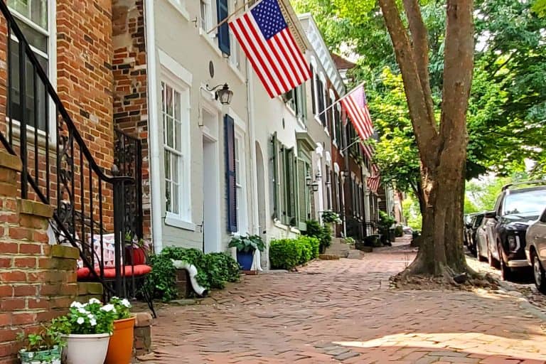 Charming Alexandria street with brick sidewalks and American Flags