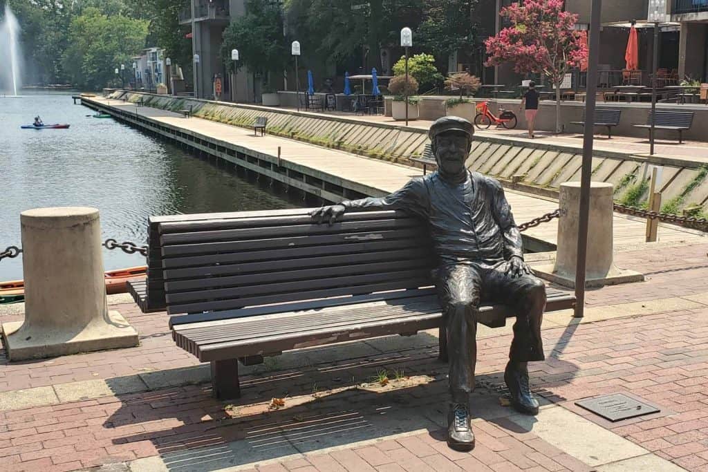 Bronze statue of Robert E. Simon Jr and bench a Lake Anne in Reston VA