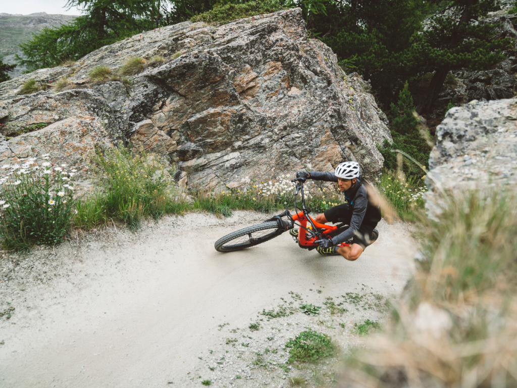Mountain biker climbing and on a turn