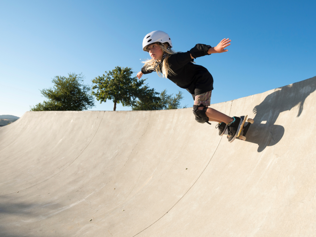 Young female skateboarder wearing a skate-specific helmet