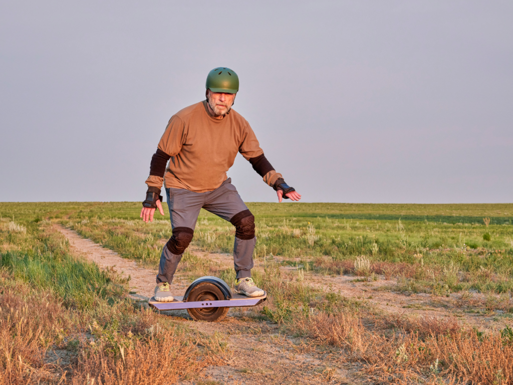 Man on a uniboard wearing a skate helmet