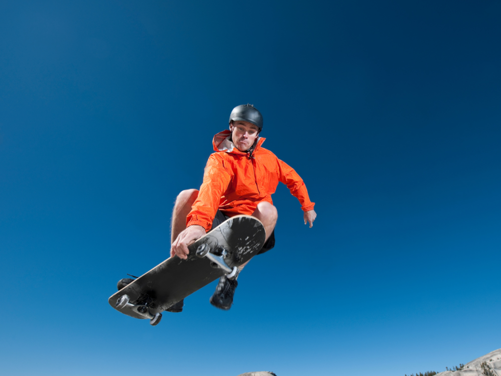 Skateboarder getting air wearing a skate helmet vs a bike helmet
