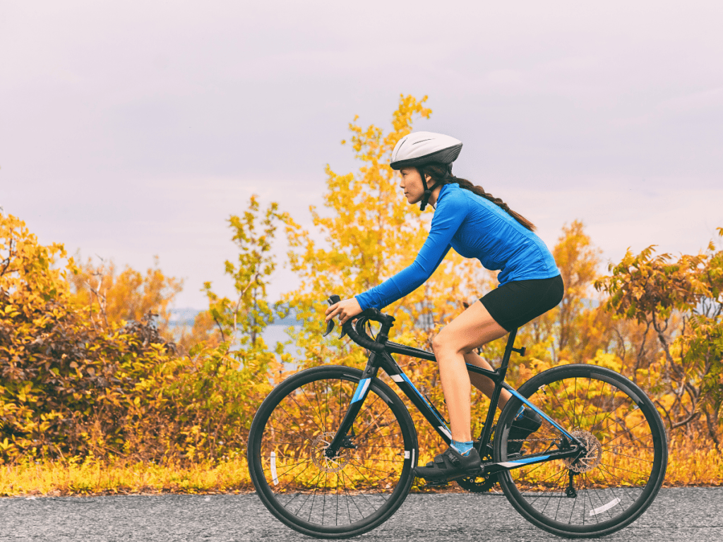 Female cyclist with her hair in a braid beneath her bike helmet