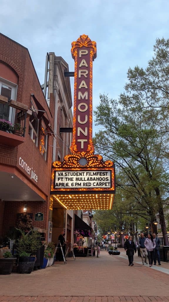 A theater sign on a brick sidewalk in Charlottesville's Historic Downtown